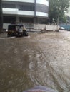 India at Mumbai water on the road and autorickshaw Driver trying to drive in water