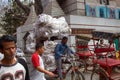 Bicycle rickshaw overloaded with bags of sugar