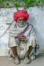 An India old man with a red Rajasthani traditional turban.