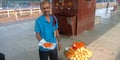 india street food vendor offering traditional sweet at railway station