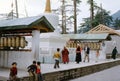 1977. India. Tibetan pilgrims and children by the praying mills. Royalty Free Stock Photo