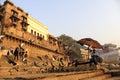 India, Varanasi Ganges river ghat with ancient city architecture as viewed from a boat on the river at Morning