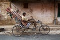 Indian Bicycle rickshaw with a load of carpets