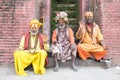 India - Varanasi. Three holy man, sadhu looking into the camera.