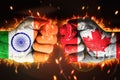 India Vs Canada clash concept background with painted fist and glowing fire behind, backdrop. Royalty Free Stock Photo