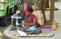 India women sitting on the city street with a baby