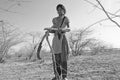 Young indian girls chopping down wood at the national park Little Rann of Kutch in the Gujarat salt-desert Royalty Free Stock Photo