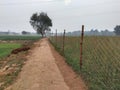 Indian agriculture land with rope fencing near road