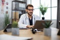 Indian arab male doctor typing on laptop in his modern office. Royalty Free Stock Photo