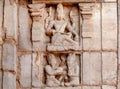 Indian art on facade of temple with Shiva Lord and ancient hindu people. 7th century carvings of Pattadakal, India