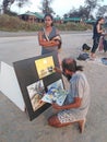 Indian artist draws hi pictures in Arambol beach by the evening. Goa, India
