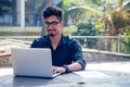 Indian Asian college student studying freelancer working with a laptop on the beach summer cafe .freelance and remote Royalty Free Stock Photo