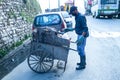 Indian Asian Garbage man collecting garbage in the garbage cart. Concept about