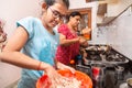 Indian/Asian Mother and Daughter working in kitchen, Young Girl kneading flour, learn to cook Due to lock down,