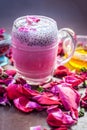 Famous Indian & Asian Summer and Ramadan drink i.e. Gulab shake or Rose falooda in a glass on wooden surface. Royalty Free Stock Photo