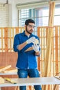 Indian Asian professional engineer architect foreman labor worker wears safety goggles glasses and gloves using square angle