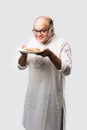 Asian Indian old man eating pizza with funny expressions Royalty Free Stock Photo