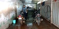 an indian automobile mechanic washing motorcycles into the bajaj service center in India