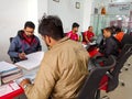 an indian automobile sales staff presenting motorcycle pamphlet during the customer deal at hero bike in India January 2020