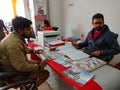 an indian automobile sales staff presenting motorcycle pamphlet during the customer deal at hero bike in India January 2020