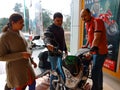 an indian automobile salesmen presenting bike model to the couple customer at showroom in India January 2020