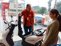 an indian automobile salesmen presenting Scotty model to the female customer at showroom in India January 2020