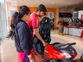 an indian automobile salesmen presenting Scotty model to the female customer at showroom in India January 2020