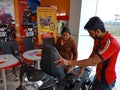 an indian automobile salesmen presenting Scotty model to the woman customer at showroom in India January 2020