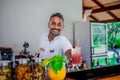 Indian bartender with cocktail at the bar counter with cocktail at the tropical resort