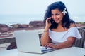 Indian beautiful businesswoman working on a modern laptop in the cafe restaurant on the shore of the paradise ocean.Web Royalty Free Stock Photo