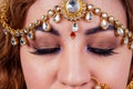 Indian beautiful fashion brunette woman in green traditional wedding rich sari with gold jewelry set nose ring piercing