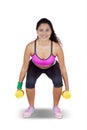 Indian beautiful woman lifting two dumbbells