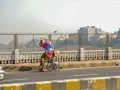 Indian beggar selling balloons on street