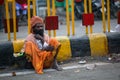 Indian beggar sitting on the street. According to legends, the city was founded by God Shiva about 5000 years ago. Royalty Free Stock Photo