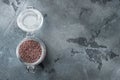 Indian Black salt, Kala namak hindi Healthy food concept, in glass jar, on gray stone background, top view flat lay , with