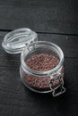 Indian Black salt, Kala namak hindi Healthy food concept, in glass jar, on black wooden background Royalty Free Stock Photo