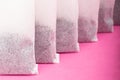 Indian black tea bags close-up on pink background Royalty Free Stock Photo