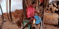 An indian blacksmith sharpen iron chopping blade belt at factory