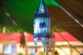 An Indian blue cloth lantern with an embroidered elephant hangs on the roof of the festival structure Royalty Free Stock Photo