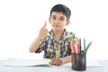 Indian boy with drawing note and pencil