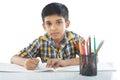 Indian boy with drawing note and pencil