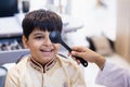 Indian boy examining eyesight checkup vision farsightedness examines ophthalmological hospital. doctor using occluder for eye