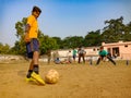 an indian boy hitting kick on football during match on ground in India January 2020 Royalty Free Stock Photo