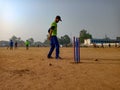 an indian boy playing cricket at ground at sky background in india January 2020 Royalty Free Stock Photo