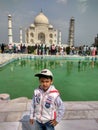 Indian boy standing in front of The Taaj Mahal which is located in Aagra Royalty Free Stock Photo