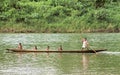 Indian boys sail with dugout canoe on river, Nicaragua Royalty Free Stock Photo
