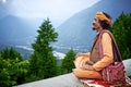 Indian Brahmin looks down from himalaya mountains