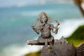 Indian brass sculpture at ocean background