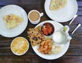 Indian breakfast - bread, spices, omlet, masala tea, corn flakes with milk.