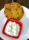 Indian breakfast dish.Stuffed potato paratha or channa dal paratha served with curd. Selective focus